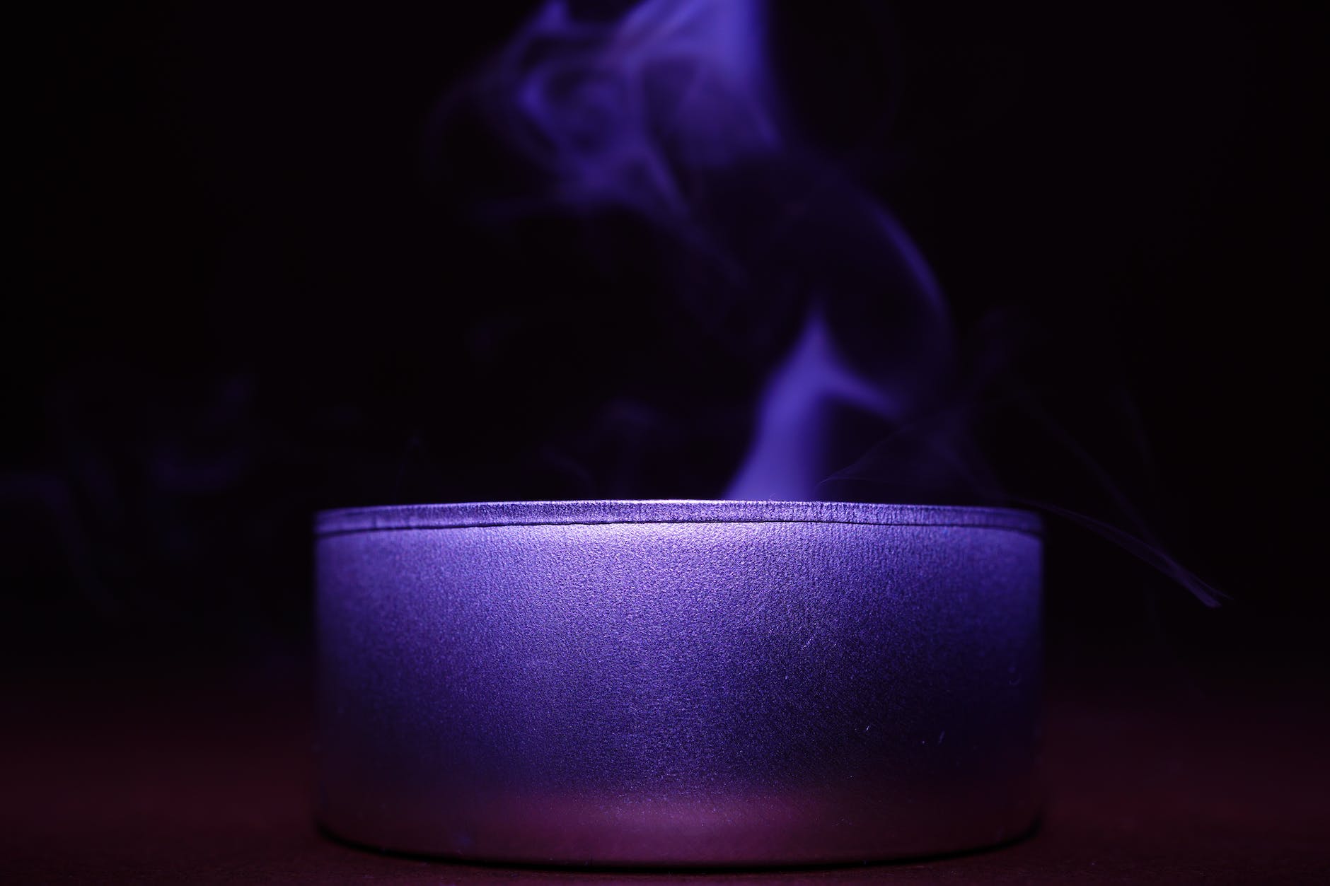 close up of blue candle against black background
